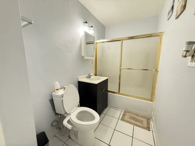 a bathroom with a sink mirror vanity and toilet