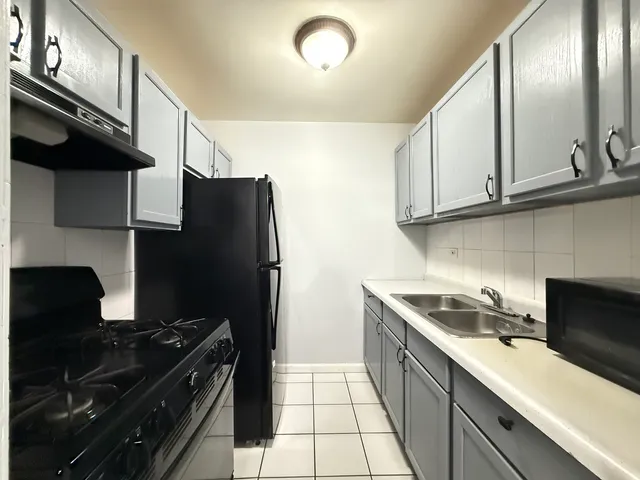 a kitchen with stainless steel appliances a sink stove and refrigerator
