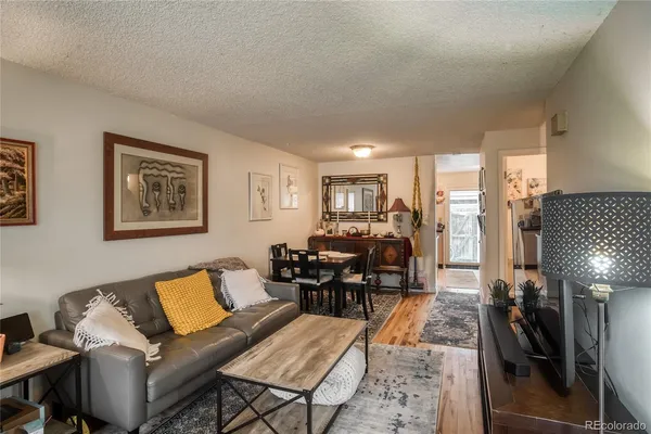 a living room with furniture and wooden floor
