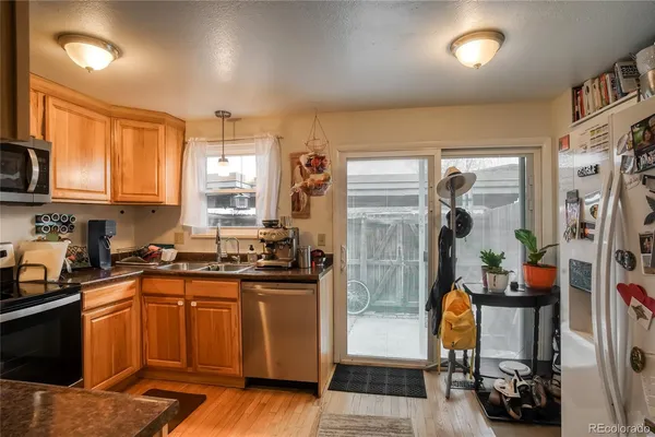 a kitchen with a sink stove and refrigerator