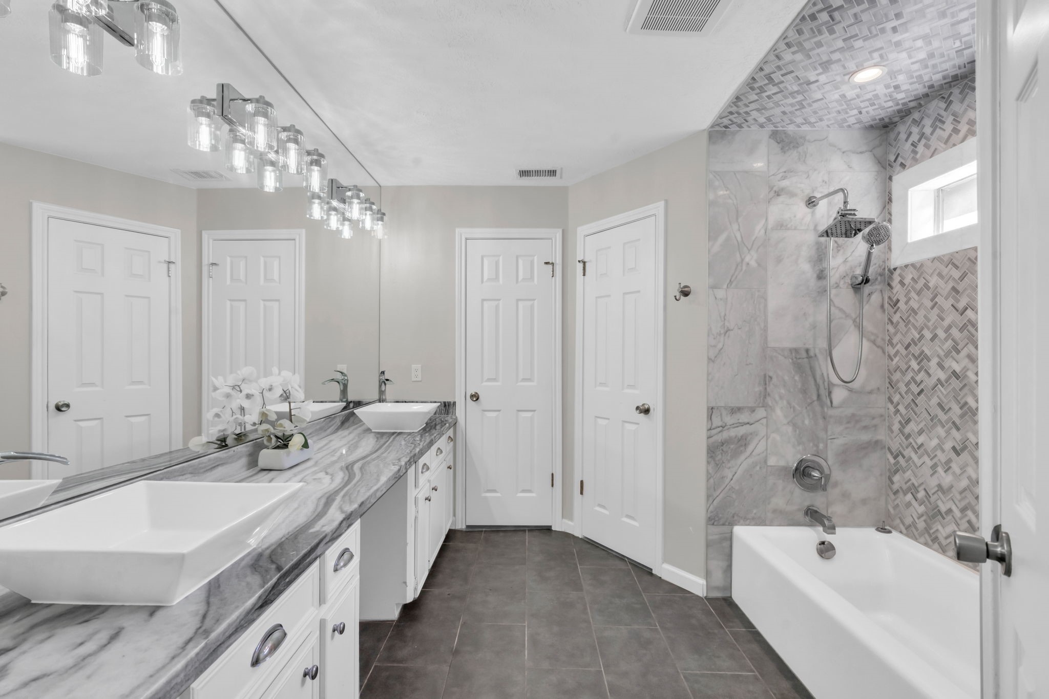 6514 Larkmount Drive Spring, TX 77389 - Photo 19 of 41 The bright, updated primary bath offers a spa like atmosphere with dual sinks and marble countertops.