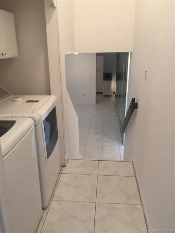 a view of storage and utility room with washer and dryer