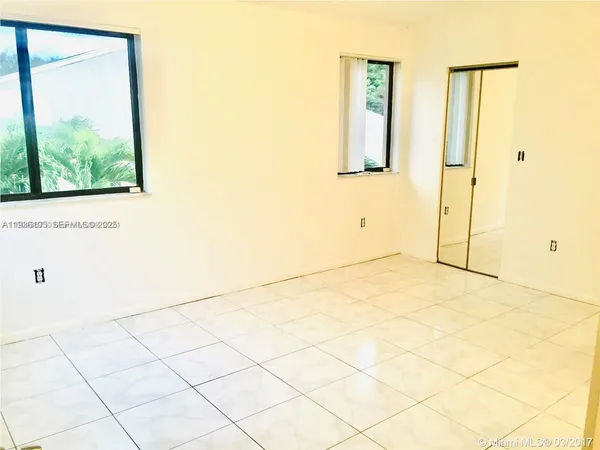 a view of empty room with windows