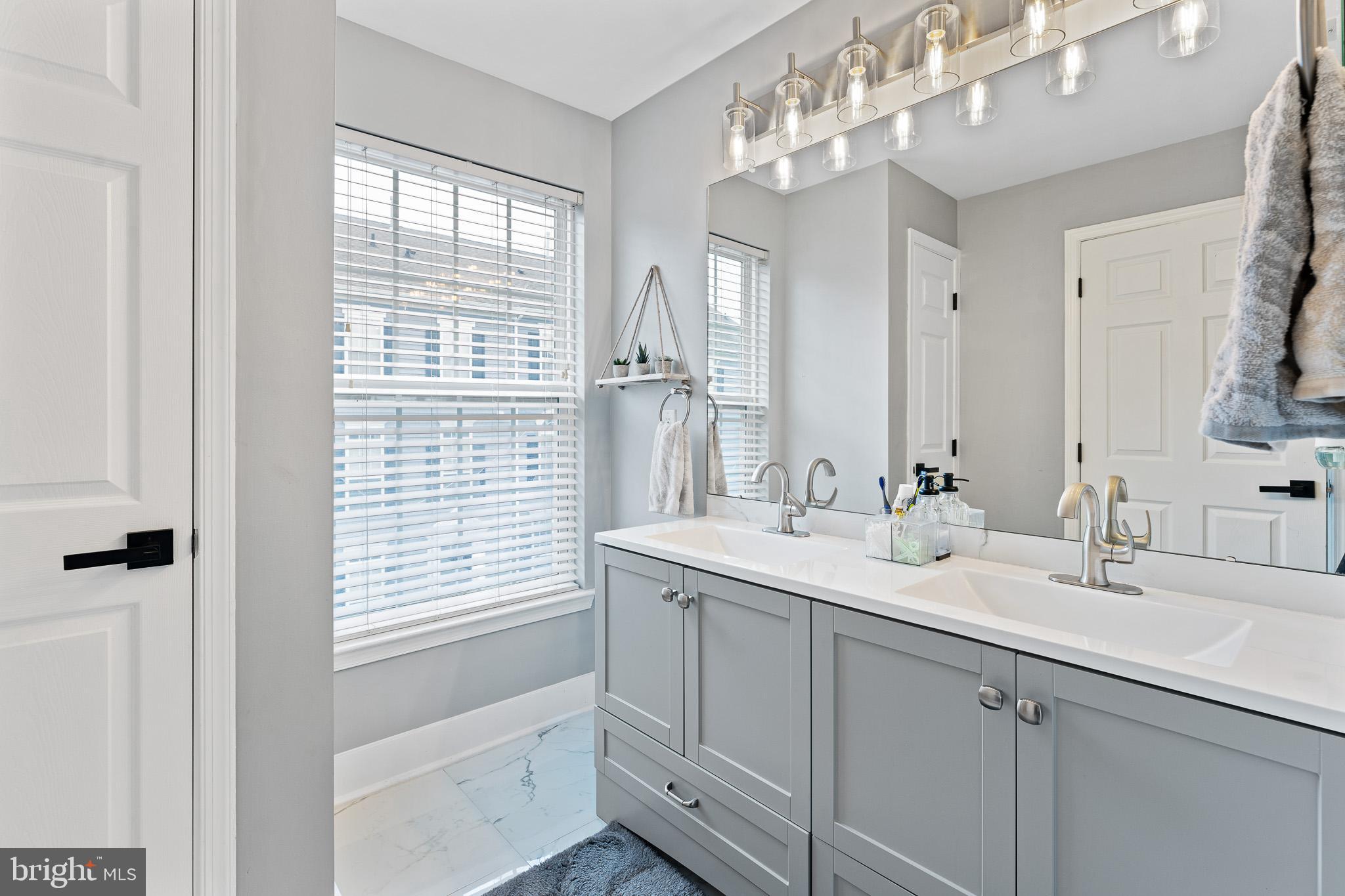 11 Teal Court Riverside, NJ 08075 - Photo 25 of 33 a bathroom with double vanity and a mirror