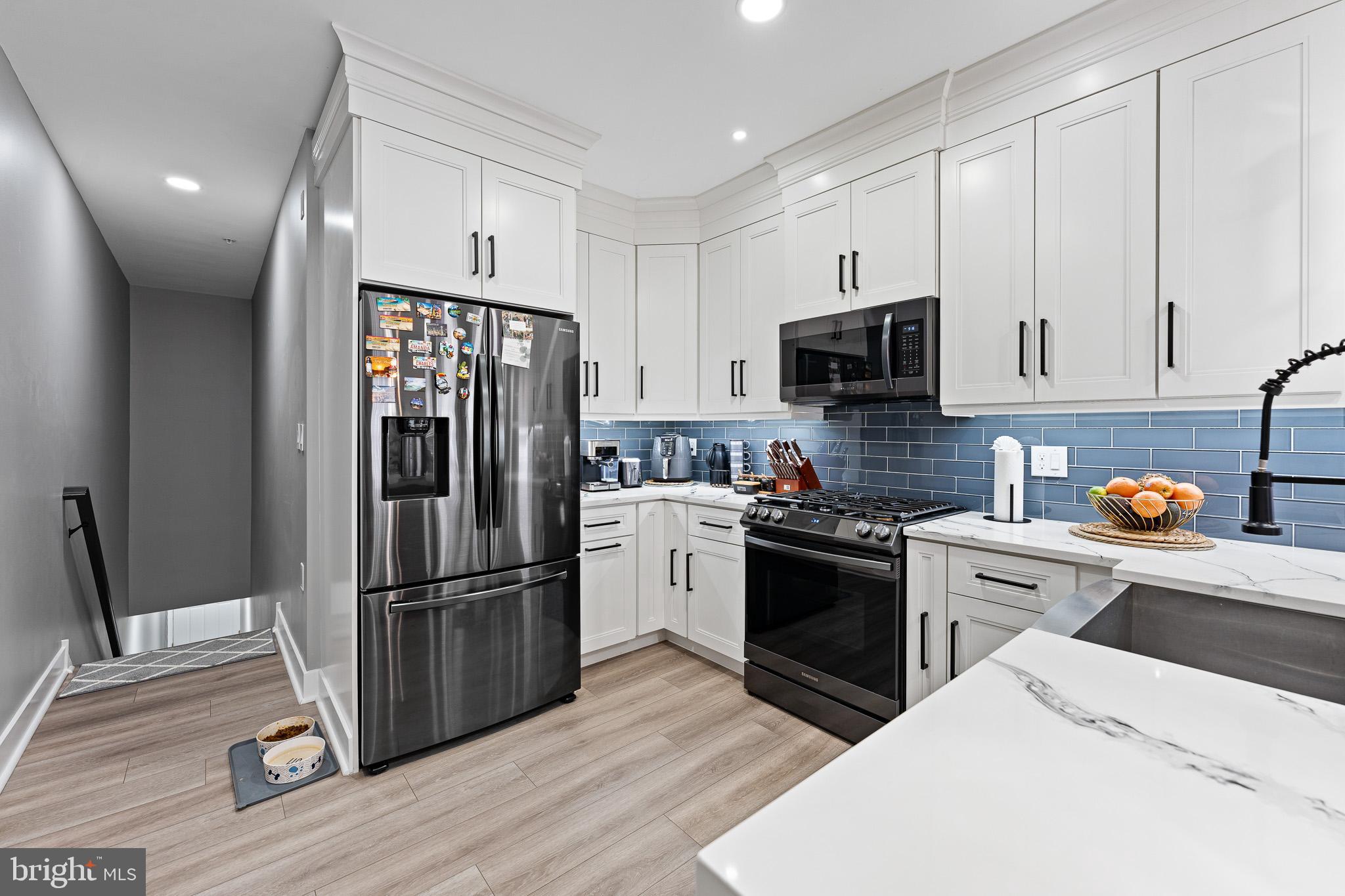 11 Teal Court Riverside, NJ 08075 - Photo 4 of 33 a kitchen with a refrigerator stove and wooden cabinets