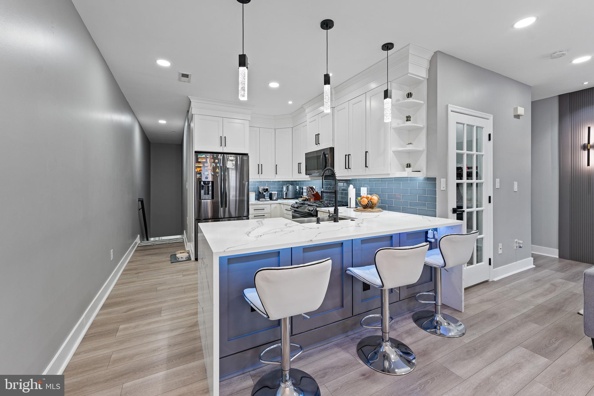 11 Teal Court Riverside, NJ 08075 - Photo 6 of 33 a room with stainless steel appliances kitchen island granite countertop a dining table chairs and a refrigerator