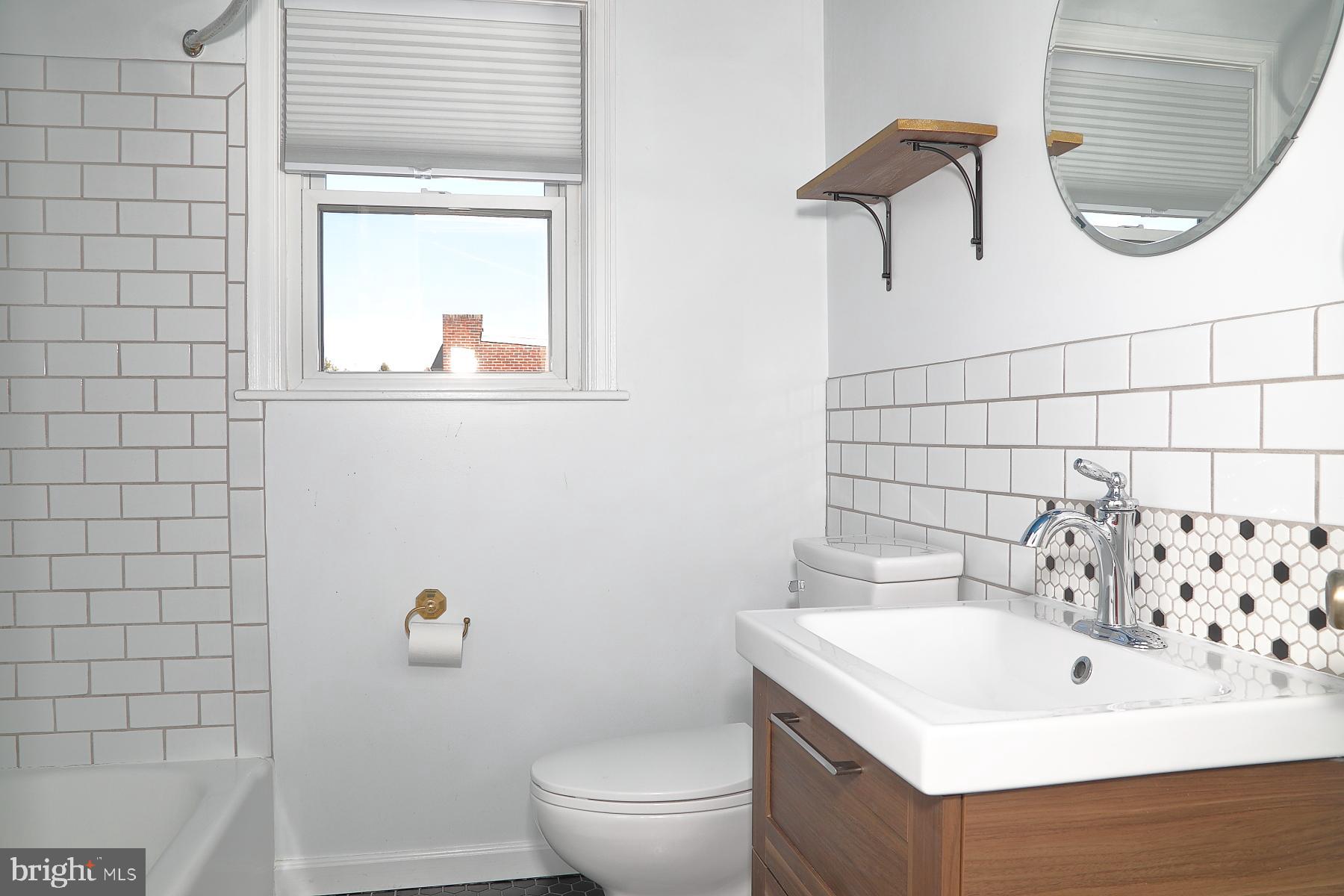 303 Euclid Avenue Lancaster, PA 17603 - Photo 20 of 24 a bathroom with a sink a toilet and a mirror