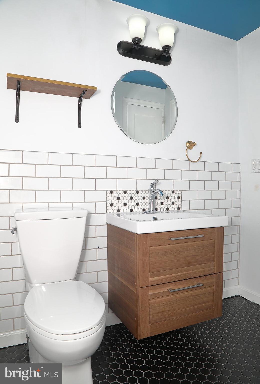 303 Euclid Avenue Lancaster, PA 17603 - Photo 21 of 24 a bathroom with a sink toilet and mirror