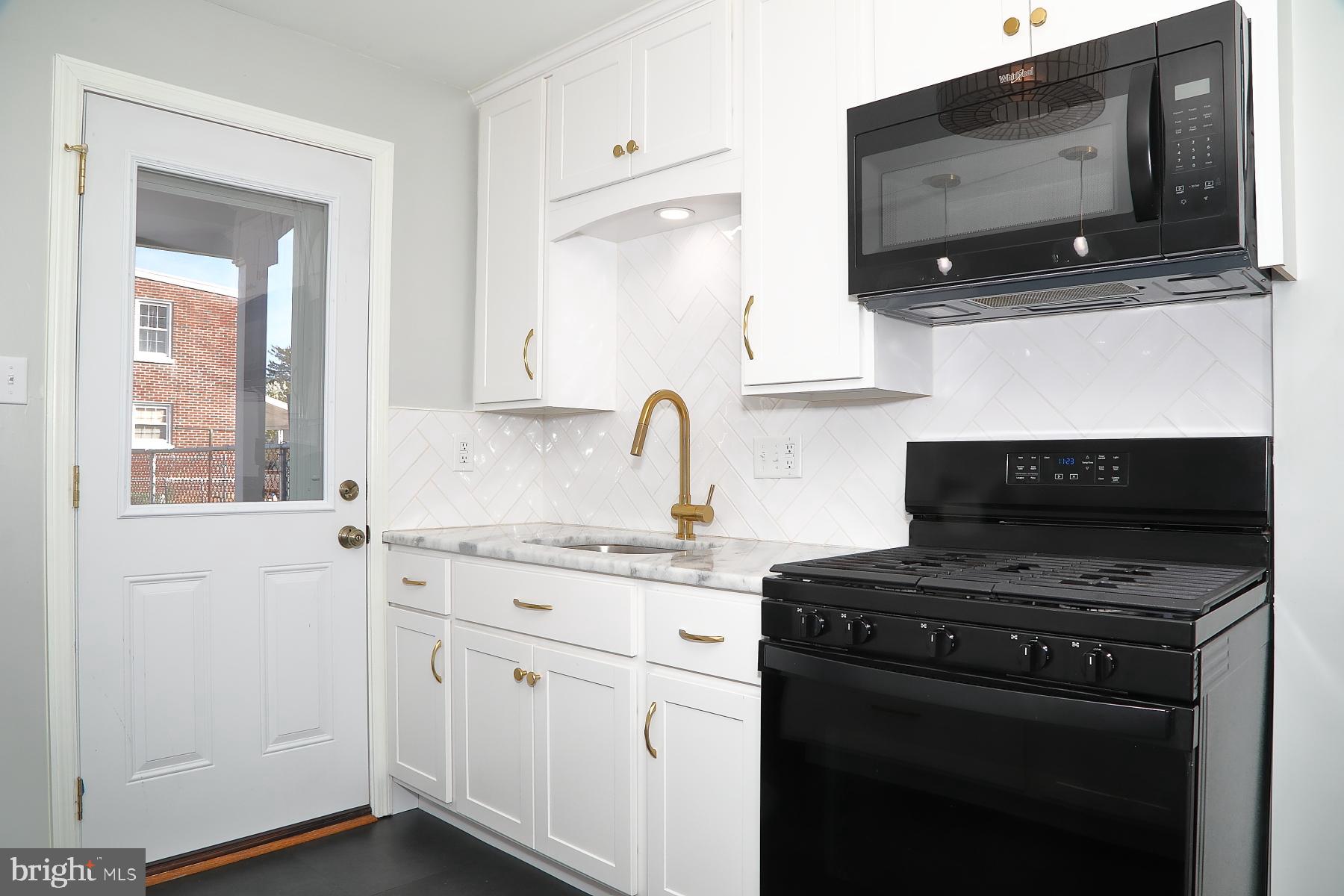 303 Euclid Avenue Lancaster, PA 17603 - Photo 7 of 24 a kitchen with stainless steel appliances a stove microwave and sink