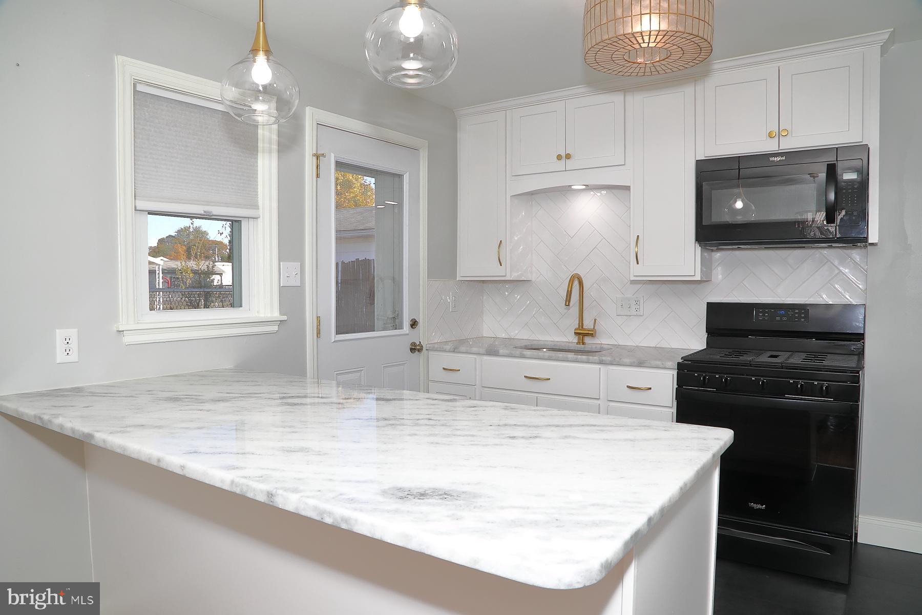 303 Euclid Avenue Lancaster, PA 17603 - Photo 9 of 24 a kitchen with kitchen island granite countertop a sink cabinets and stainless steel appliances