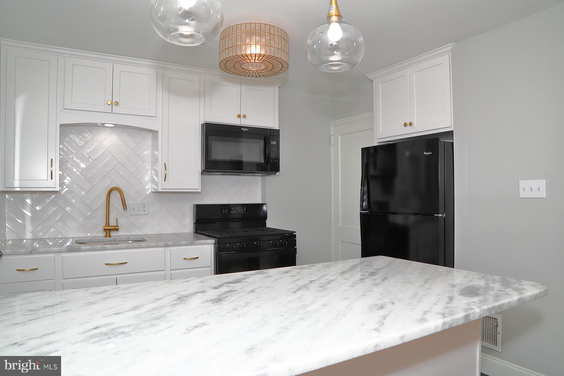 303 Euclid Avenue Lancaster, PA 17603 - Photo 10 of 24 a kitchen with granite countertop stainless steel appliances a stove microwave and refrigerator