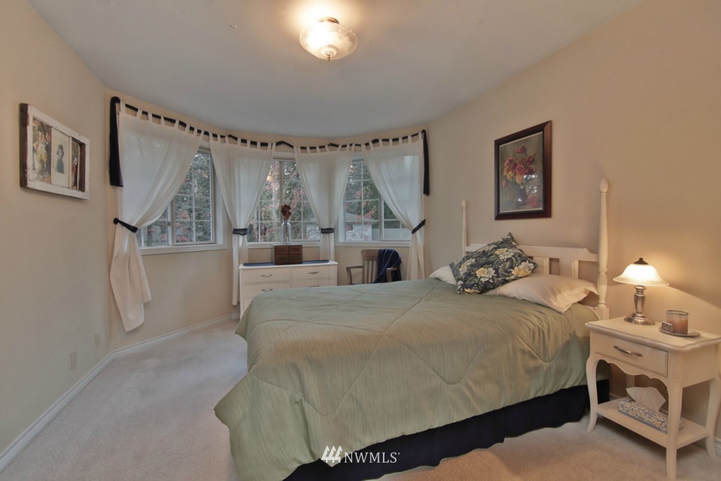 21828 49th Avenue Southeast Bothell, WA 98021 - Photo 14 of 22 a bedroom with a bed and a chandelier