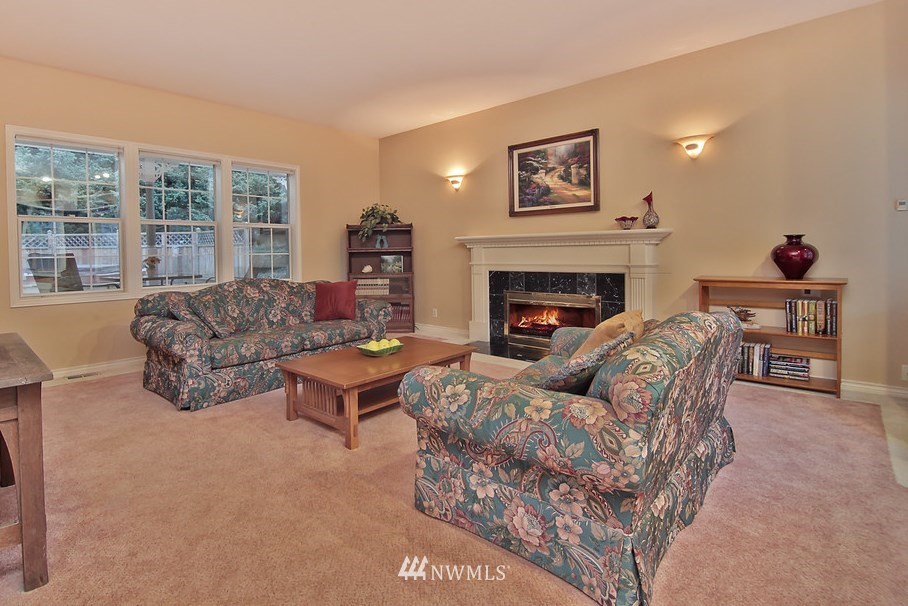 21828 49th Avenue Southeast Bothell, WA 98021 - Photo 3 of 22 a living room with furniture and a fireplace