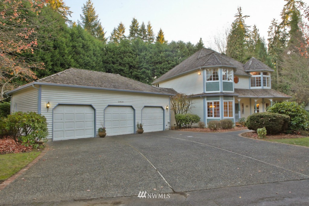 21828 49th Avenue Southeast Bothell, WA 98021 - Photo 22 of 22 a front view of a house with a garden and trees