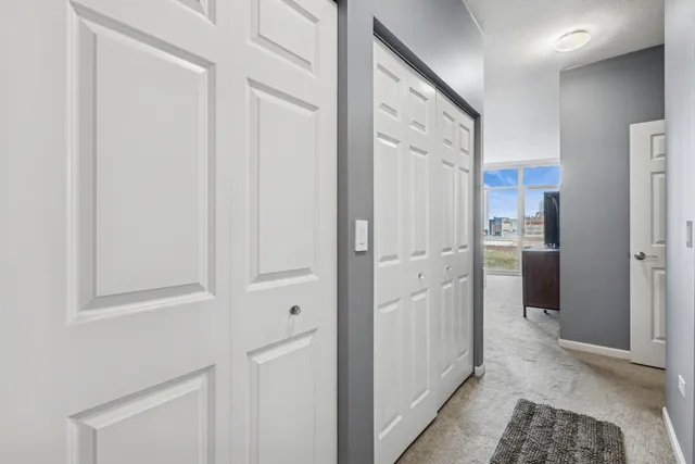 a view of a kitchen with white cabinets and refrigerator