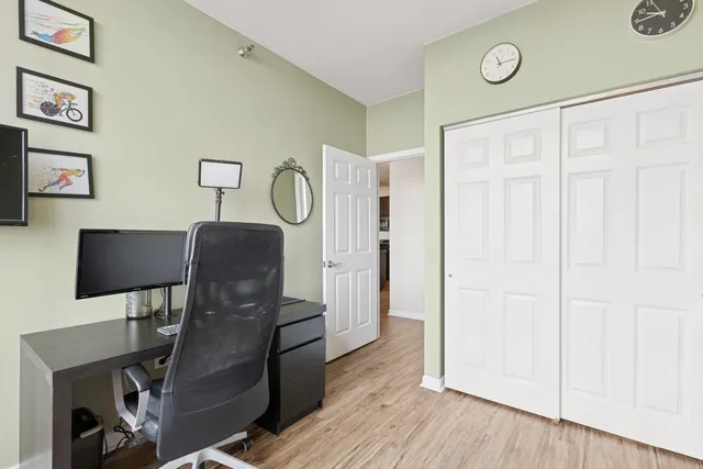 a view of a workspace with furniture and wooden floor