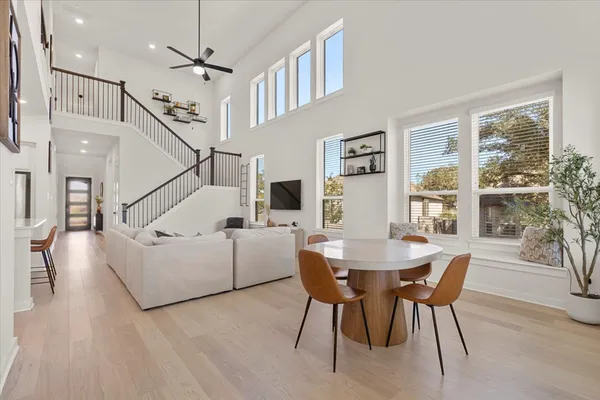 a dining room with furniture a chandelier and wooden floor
