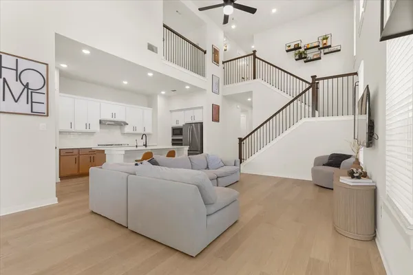 a living room with furniture and wooden floor