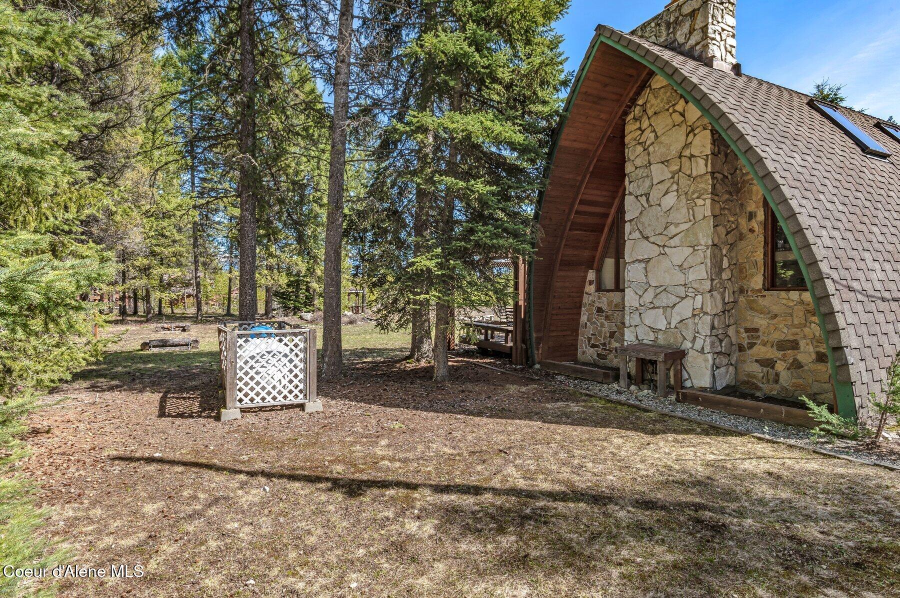 762 Reeder Bay Road Nordman, ID 83848 - Photo 33 of 74 Exterior Fireplace Main Home