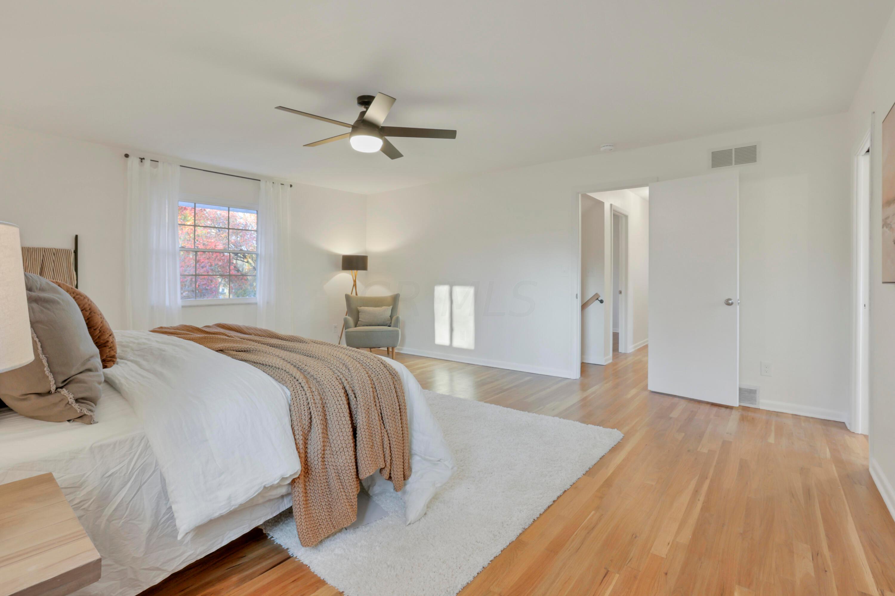 2275 Haverford Road Columbus, OH 43220 - Photo 26 of 57 The spacious Primary Suite offers refinished hardwood floors, ceiling fan, walk-in closet and en suite bathroom.