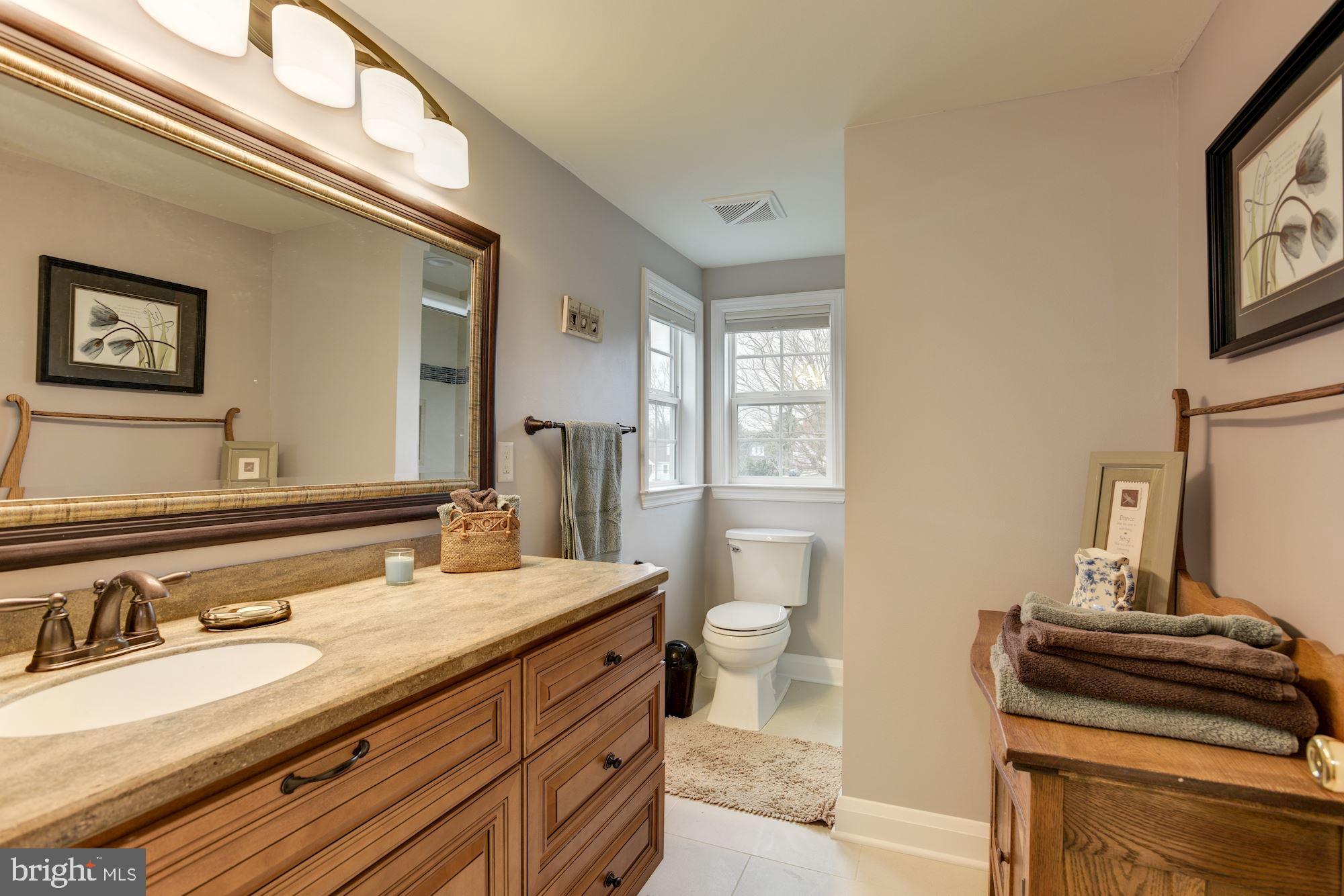 306 Homewood Road Linthicum, MD 21090 - Photo 21 of 32 a bathroom with a sink and a mirror