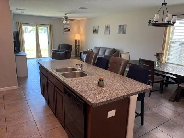 a kitchen with a kitchen island a sink a table and chairs