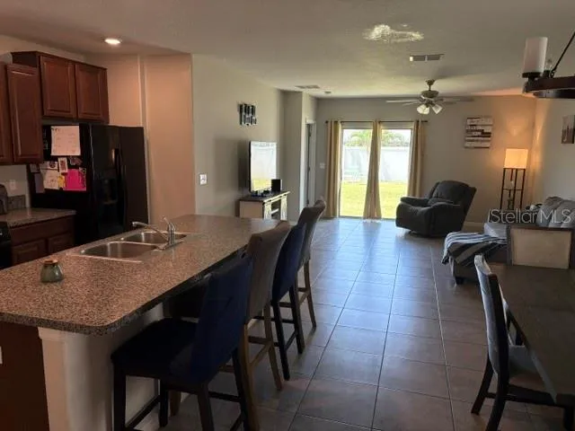 a kitchen with a table chairs refrigerator and microwave