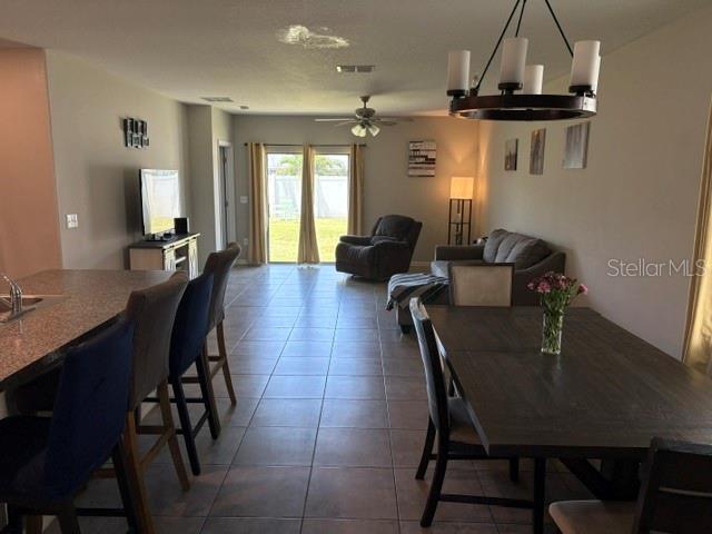 9616 Lemon Drop Loop Sun City Center, FL 33573 - Photo 14 of 48 a dining room with furniture and window