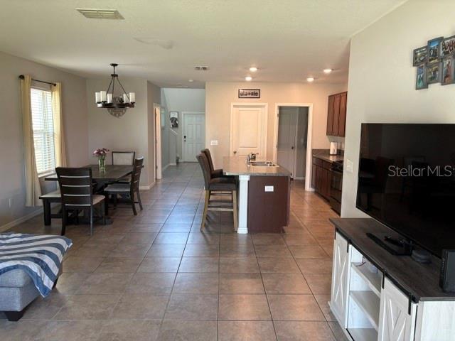 9616 Lemon Drop Loop Sun City Center, FL 33573 - Photo 19 of 48 a lobby with furniture and flat screen tv