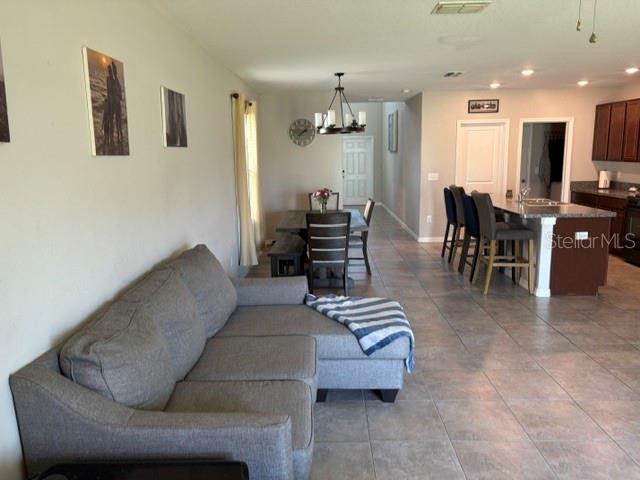9616 Lemon Drop Loop Sun City Center, FL 33573 - Photo 20 of 48 a living room with furniture and wooden floor