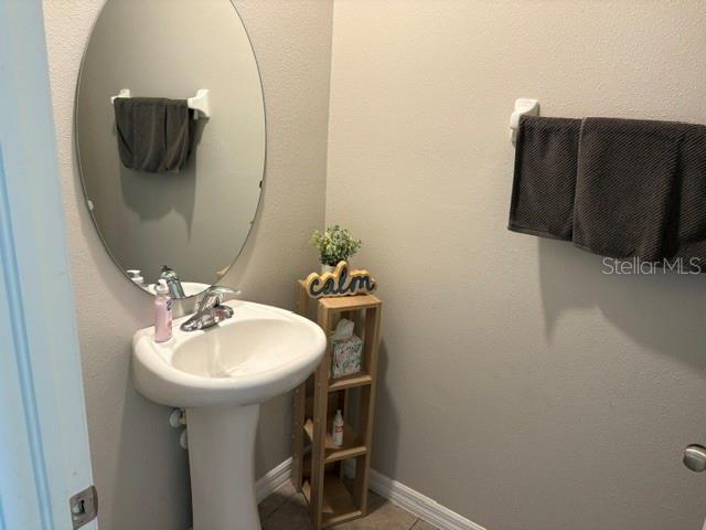 9616 Lemon Drop Loop Sun City Center, FL 33573 - Photo 22 of 48 a bathroom with a sink and mirror