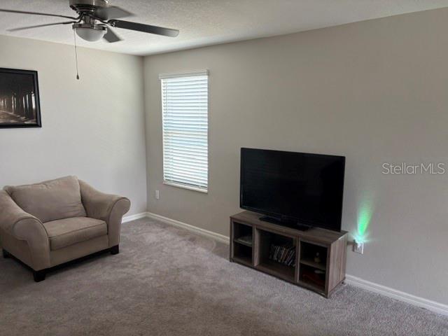 9616 Lemon Drop Loop Sun City Center, FL 33573 - Photo 25 of 48 a living room with furniture and a flat screen tv