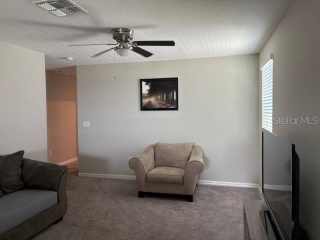 9616 Lemon Drop Loop Sun City Center, FL 33573 - Photo 26 of 48 a living room with furniture and a ceiling fan