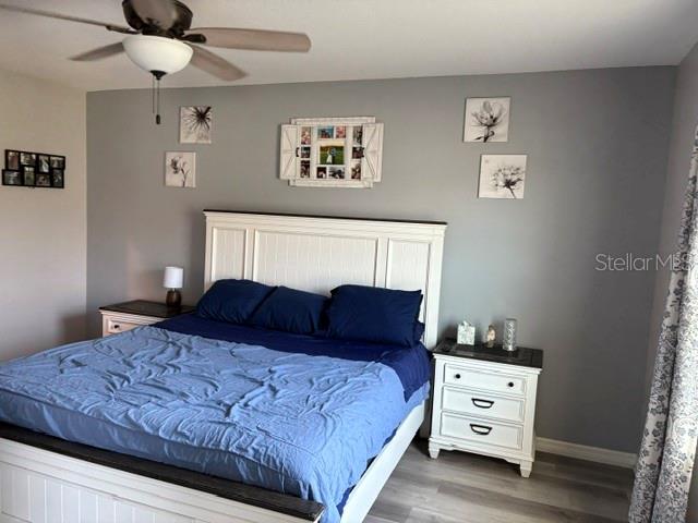 9616 Lemon Drop Loop Sun City Center, FL 33573 - Photo 28 of 48 a bedroom with a bed and a window