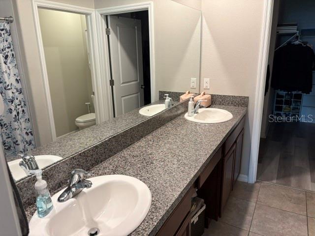 9616 Lemon Drop Loop Sun City Center, FL 33573 - Photo 29 of 48 a bathroom with a granite countertop sink and a mirror