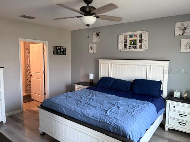 9616 Lemon Drop Loop Sun City Center, FL 33573 - Photo 30 of 48 a bedroom with a bed and window