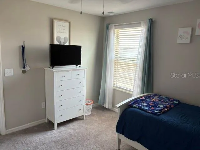 a view of dining room and bedroom with furniture