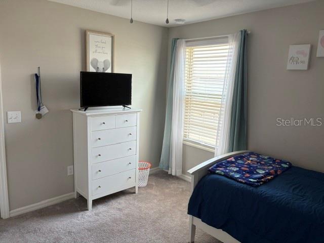 9616 Lemon Drop Loop Sun City Center, FL 33573 - Photo 36 of 48 a bedroom with a bed and a flat screen tv