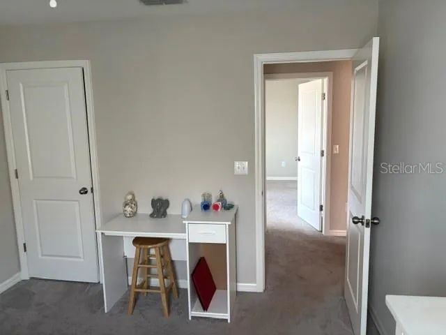 a bedroom with a bed and a desk