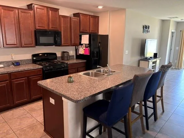 a kitchen with a granite countertop sink cabinets and stainless steel appliances
