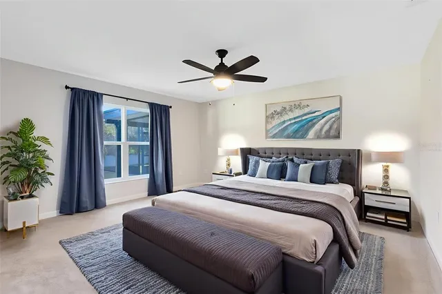 a bedroom with a large bed and a chandelier