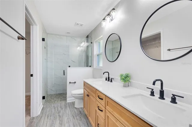 a bathroom with a double vanity sink and a mirror