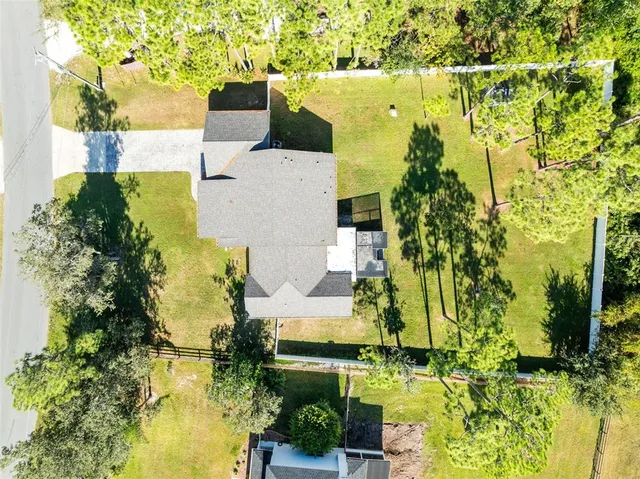 an aerial view of residential houses with outdoor space and swimming pool