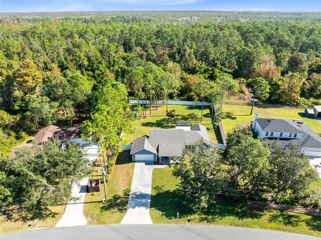 an aerial view of house with yard swimming pool and outdoor seating