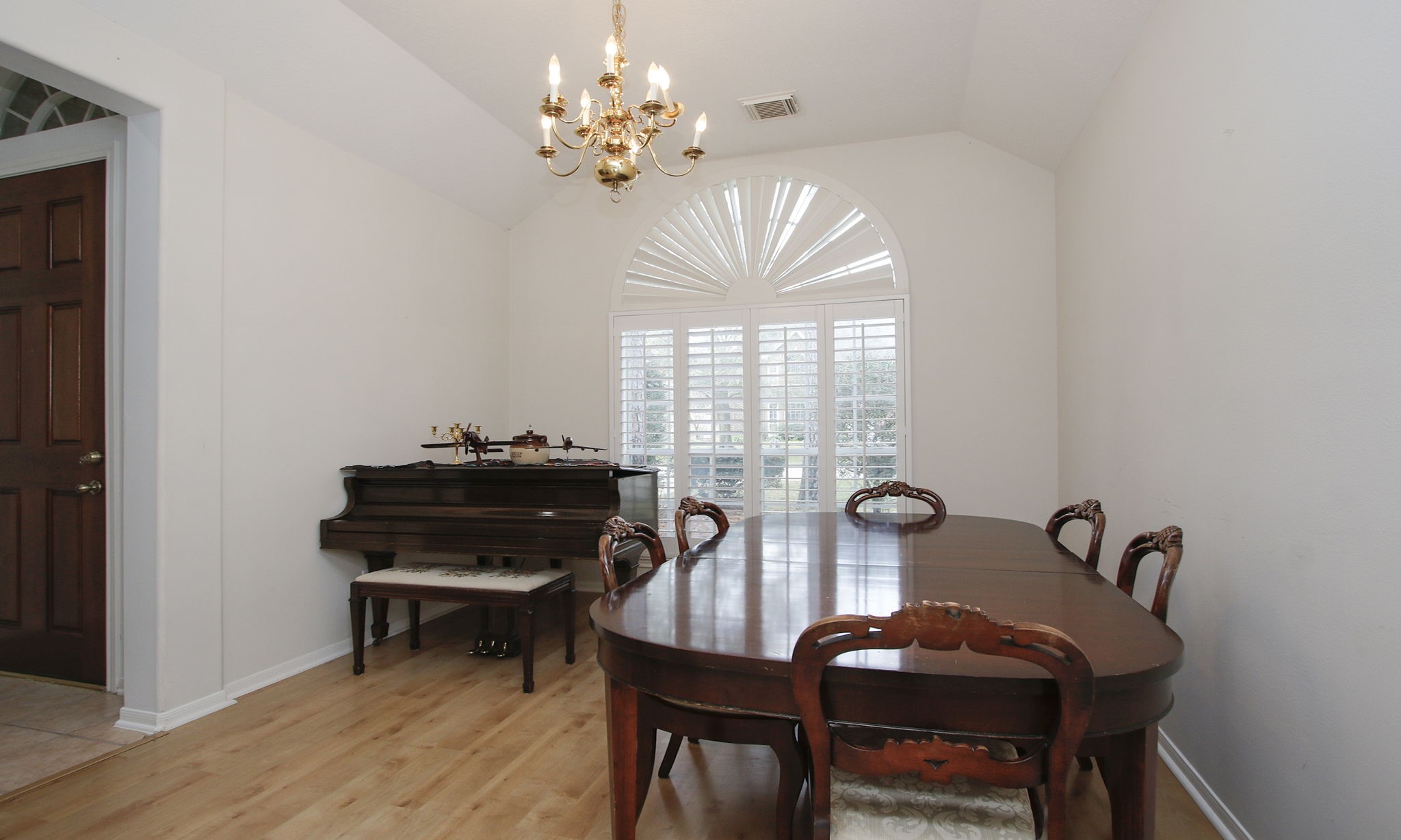 20206 Treetop Lane Spring, TX 77388 - Photo 11 of 42 a view of a dining room with furniture a chandelier and wooden floor