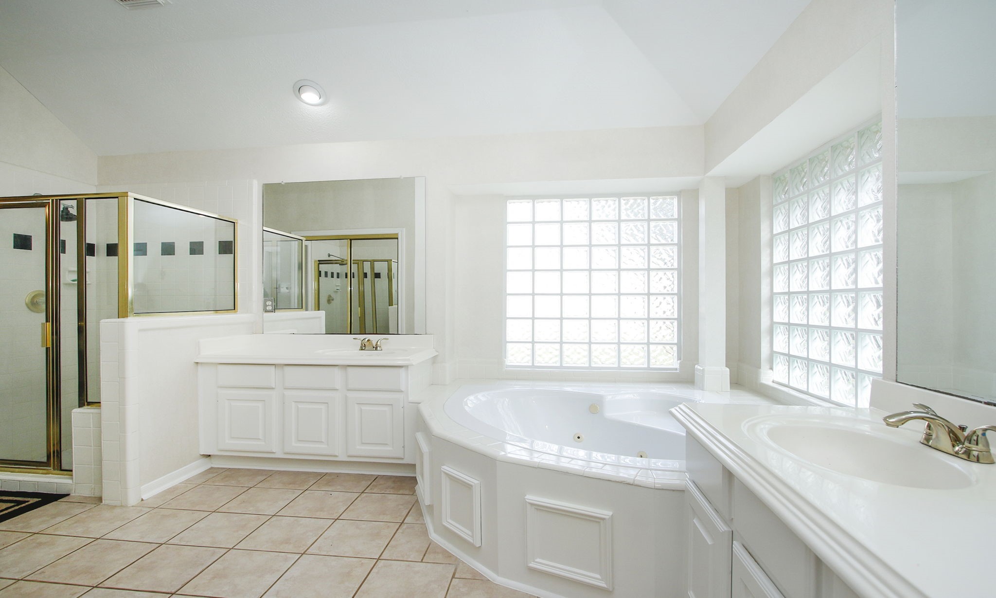 20206 Treetop Lane Spring, TX 77388 - Photo 27 of 42 a spacious bathroom with a tub sink and mirror