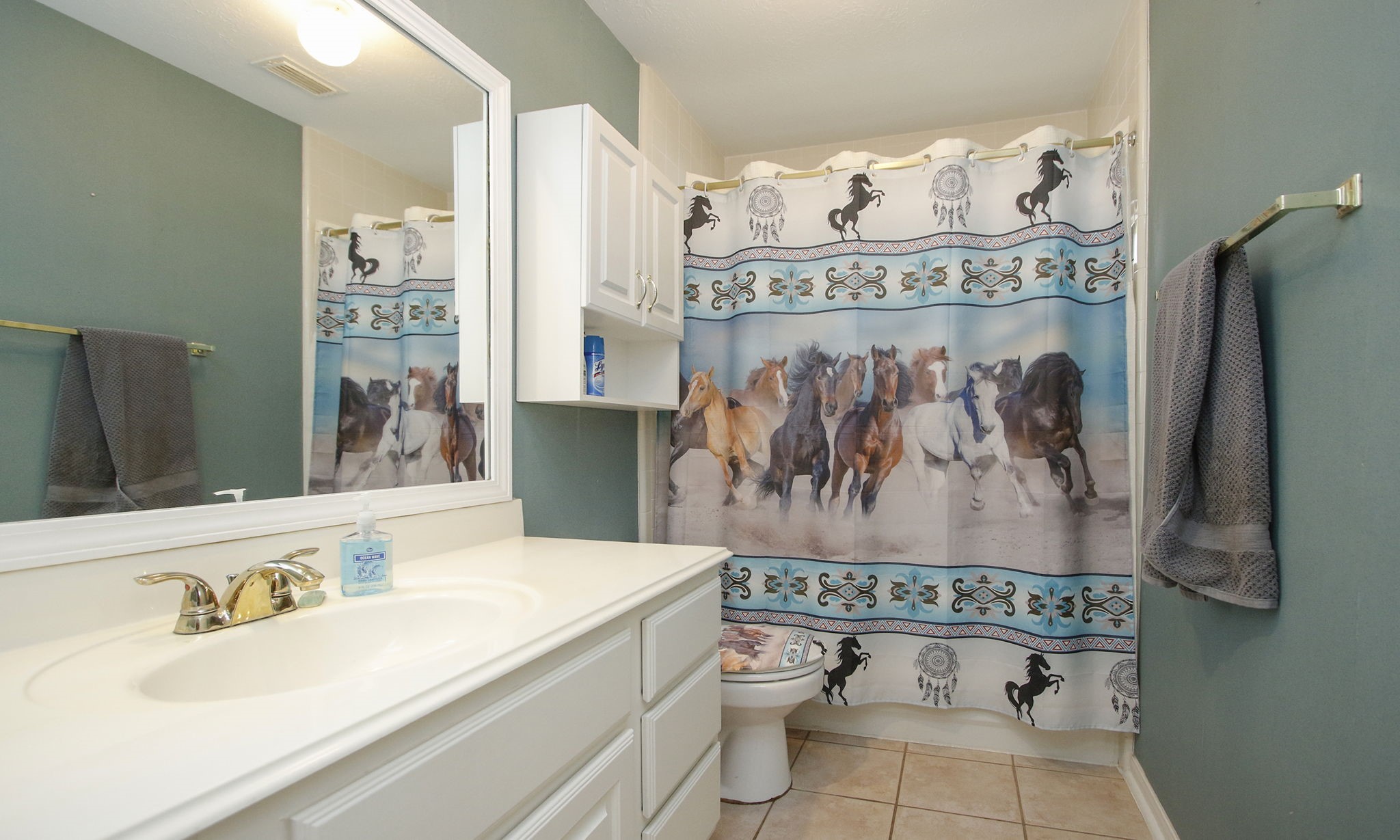 20206 Treetop Lane Spring, TX 77388 - Photo 31 of 42 a bathroom with a sink a toilet and a shower curtain