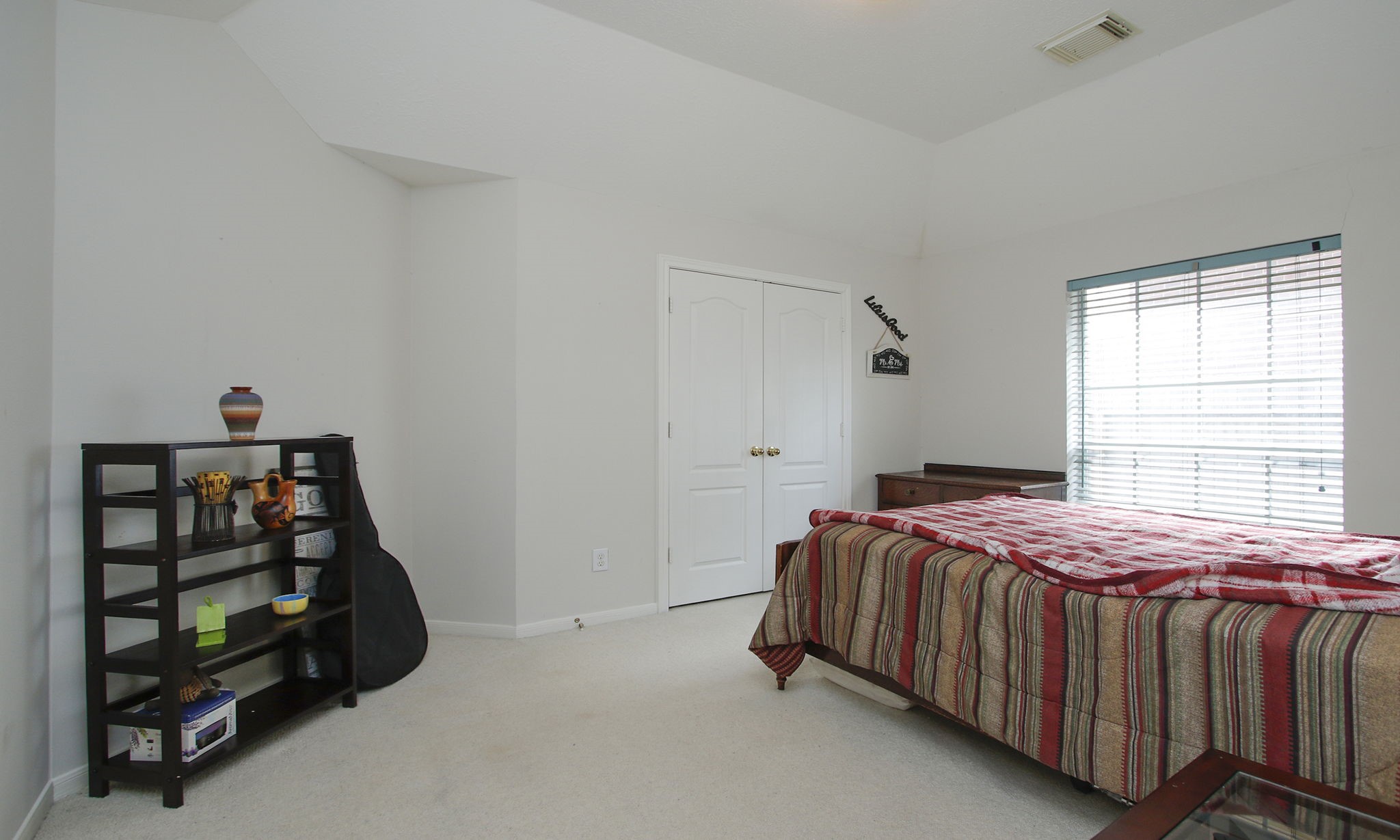20206 Treetop Lane Spring, TX 77388 - Photo 32 of 42 a bedroom with a bed a window and closet