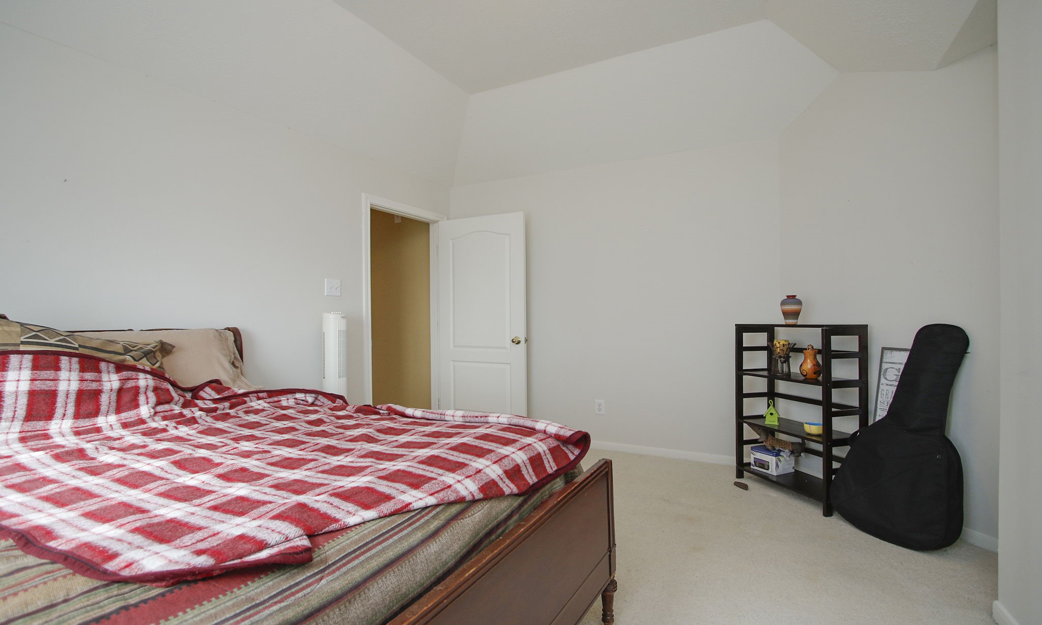 20206 Treetop Lane Spring, TX 77388 - Photo 33 of 42 a bedroom with a bed a lamp and a large closet