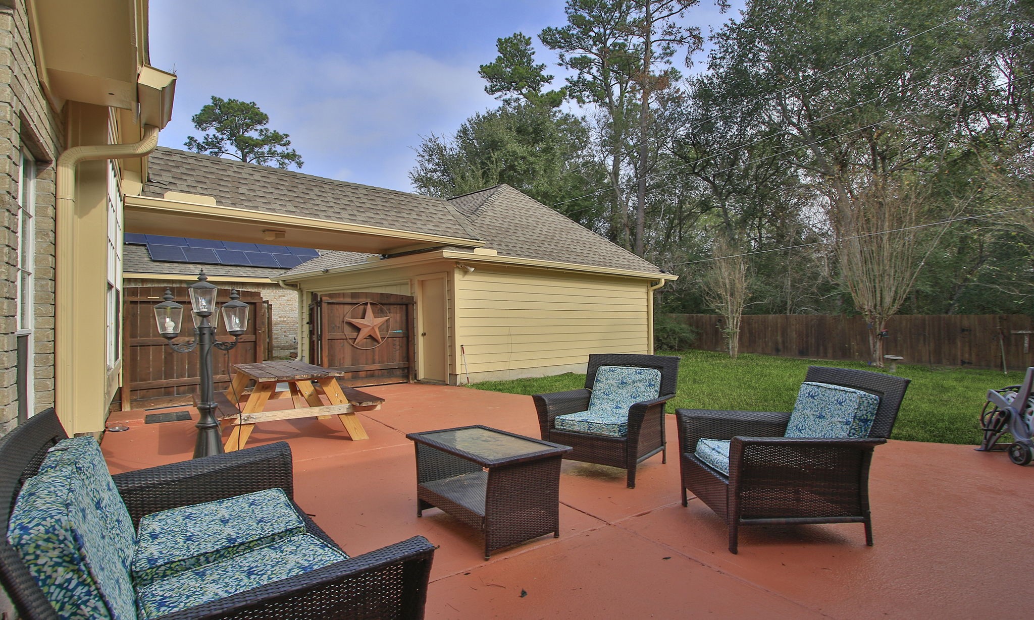 20206 Treetop Lane Spring, TX 77388 - Photo 35 of 42 a view of a patio with couches table and chairs with wooden fence and plants